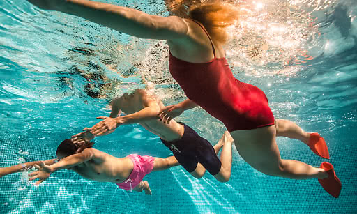 Människor som simmar i pool 
